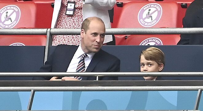 Prince William seen on the edge of a soccer field watching his son George play